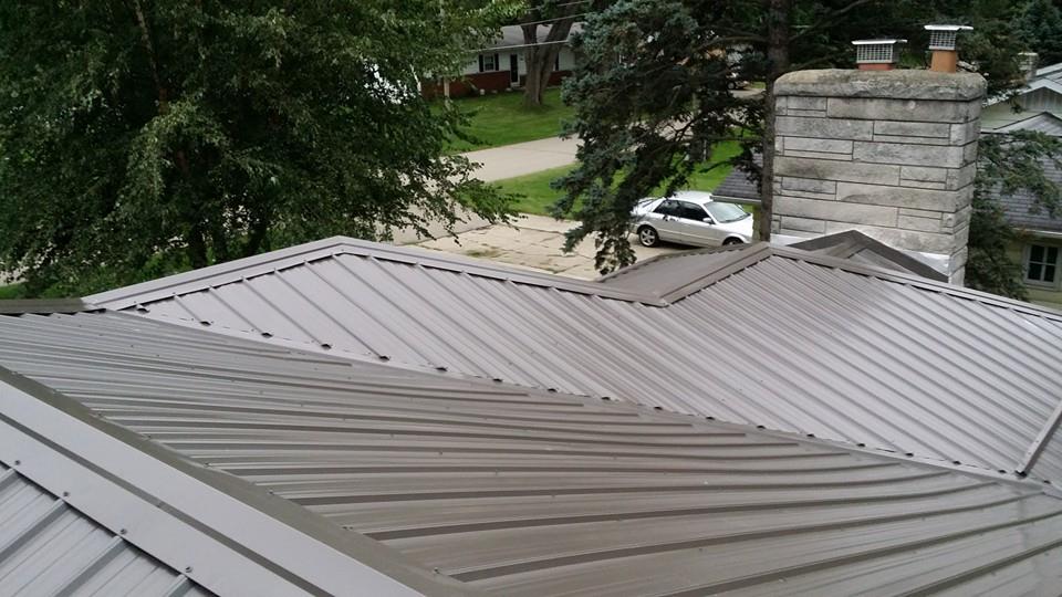 exposed a metal roof with a chimney and shingles